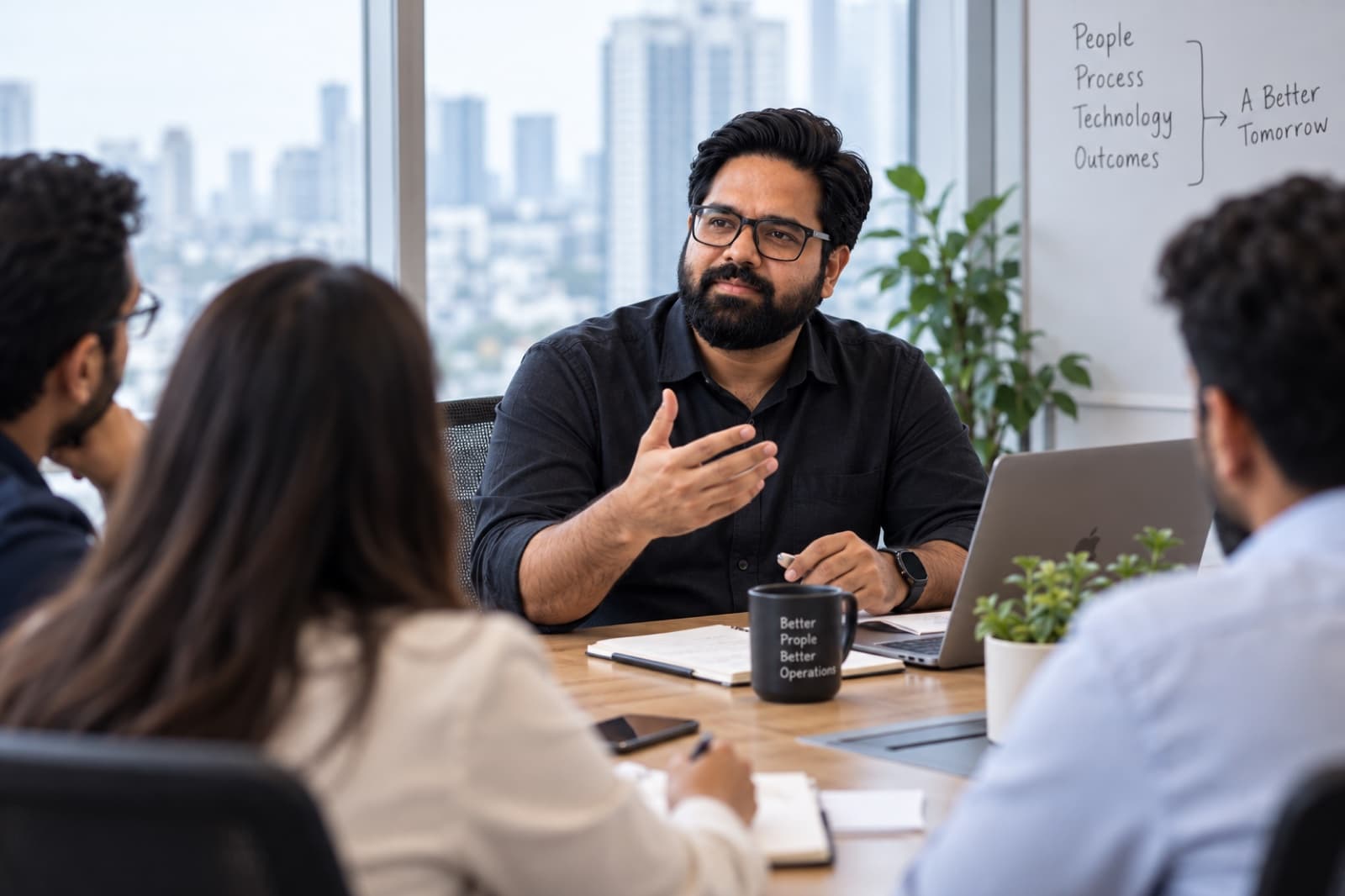 Ajit Sharma explaining an operating model to colleagues around a meeting table